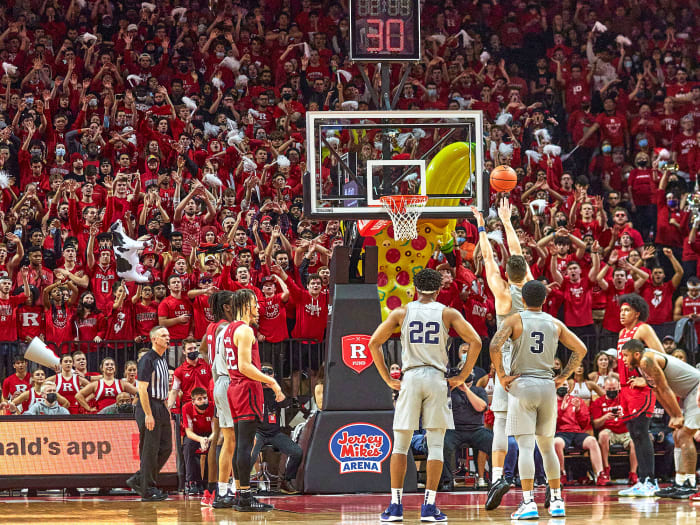 Rutgers students wave their arms during an opposing free throw